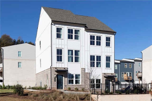 357 Skylar Ct SE, Atlanta, GA 30315 - view of front of home with board and batten siding, brick siding, and roof with shingles