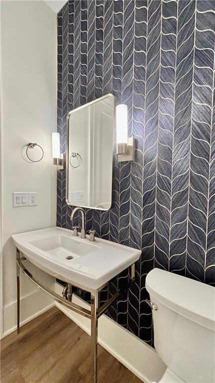 bathroom featuring toilet and wood finished floors