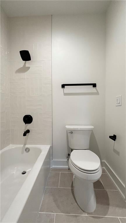 bathroom featuring tile patterned floors, toilet, and baseboards