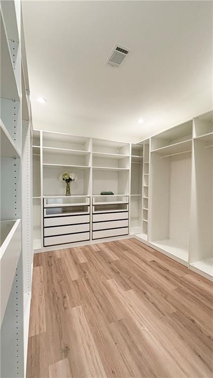 walk in closet featuring visible vents and wood finished floors