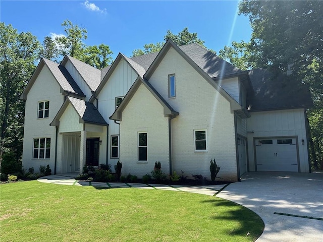 view of front of home featuring driveway, a front lawn, board and batten siding, a garage, and brick siding