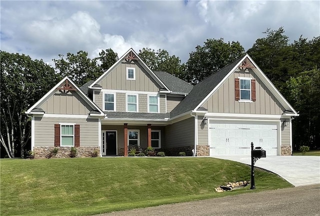 craftsman inspired home featuring a garage and a front lawn