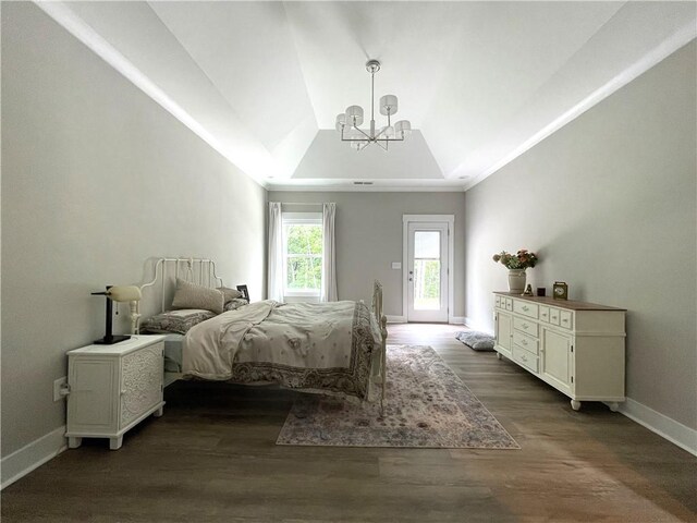 bedroom featuring a raised ceiling, lofted ceiling, dark hardwood / wood-style flooring, and a notable chandelier