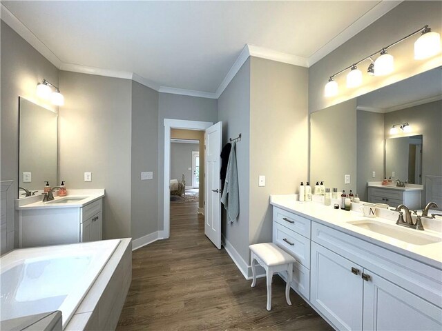 bathroom featuring wood-type flooring, vanity, and crown molding