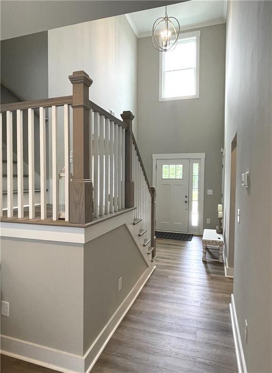 520 Stoneledge Dr, Jasper, GA 30143 - foyer featuring baseboards, ornamental molding, wood finished floors, stairway, and an inviting chandelier