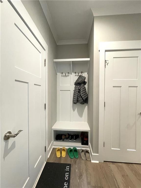 mudroom featuring hardwood / wood-style flooring and crown molding