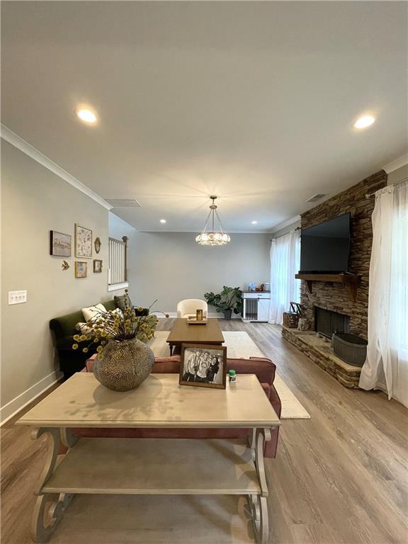 520 Stoneledge Dr, Jasper, GA 30143 - dining room featuring crown molding, recessed lighting, baseboards, a stone fireplace, and wood finished floors