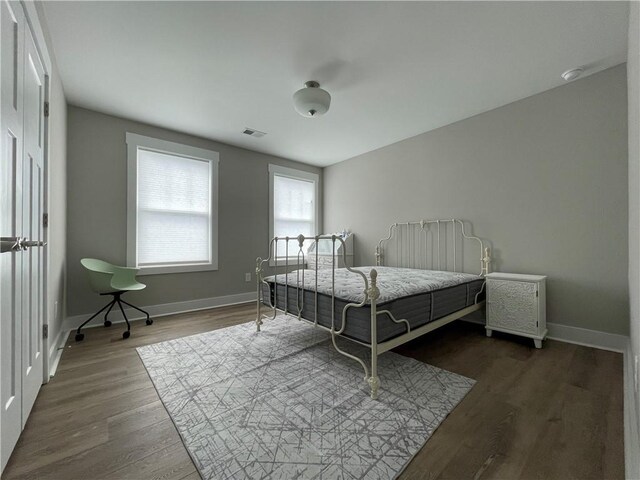 bedroom with dark wood-type flooring