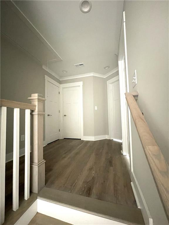 interior space with wood-type flooring and crown molding