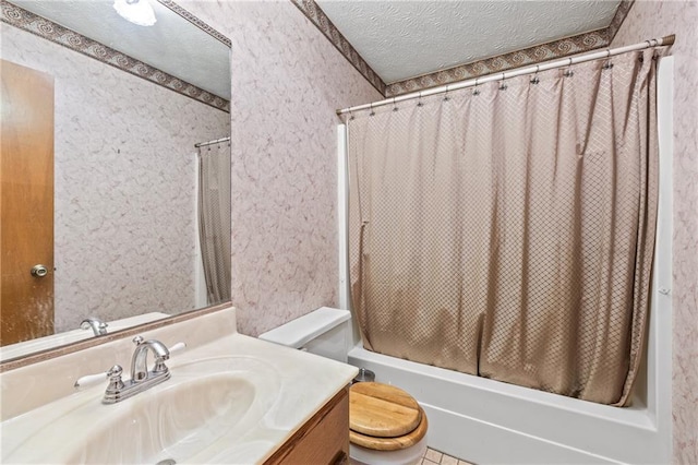 full bathroom featuring a textured ceiling, toilet, vanity, and shower / tub combo with curtain