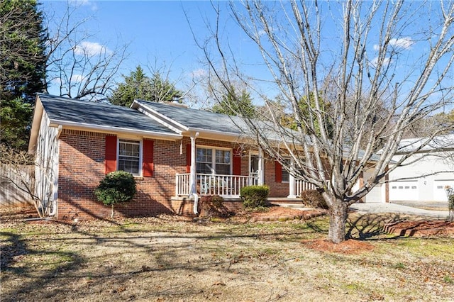 ranch-style home featuring a front lawn, a porch, and a garage