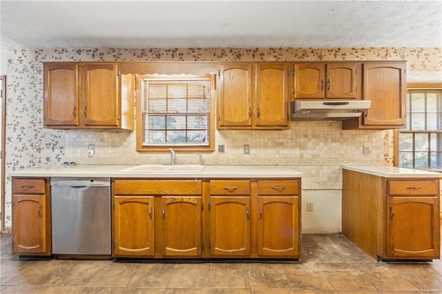 kitchen with tasteful backsplash, dishwasher, and sink