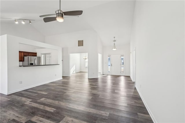 unfurnished living room featuring high vaulted ceiling, ceiling fan with notable chandelier, dark wood-type flooring, visible vents, and baseboards