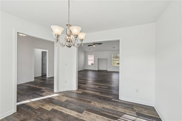 unfurnished dining area featuring dark wood-style floors, ceiling fan with notable chandelier, and baseboards