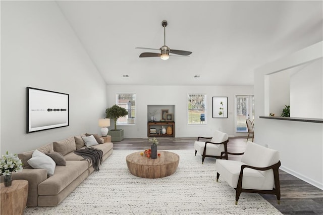 living room with lofted ceiling, wood finished floors, visible vents, and a ceiling fan