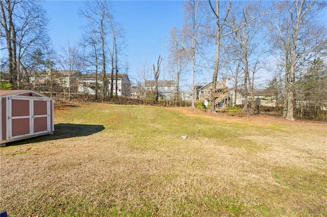 view of yard featuring an outbuilding and a storage unit