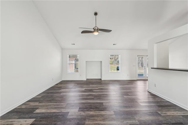 spare room featuring dark wood-type flooring, visible vents, baseboards, and a ceiling fan