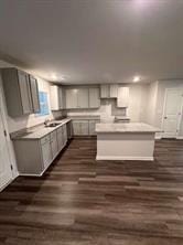 kitchen featuring a center island, gray cabinetry, and dark hardwood / wood-style floors