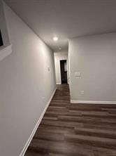 hallway with dark hardwood / wood-style floors