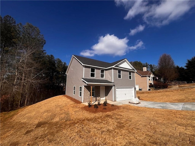 view of front of house featuring a garage and a front yard