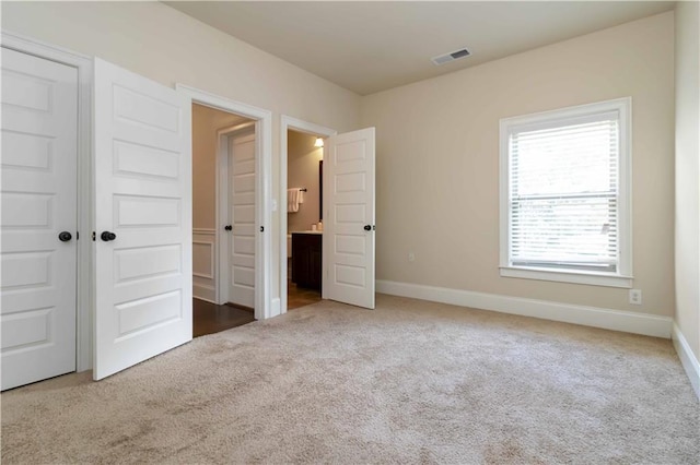 4249 Caveat Ct, Fairburn, GA 30213 - unfurnished bedroom with carpet, connected bathroom, and a closet