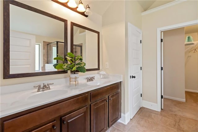 4249 Caveat Ct, Fairburn, GA 30213 - bathroom featuring double vanity, a stall shower, vaulted ceiling, and a walk in closet