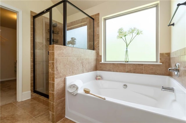 4249 Caveat Ct, Fairburn, GA 30213 - full bathroom with a stall shower, a garden tub, and tile patterned flooring