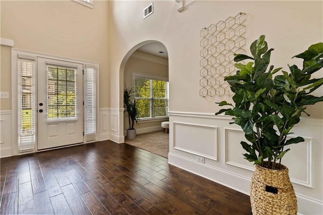 4249 Caveat Ct, Fairburn, GA 30213 - entryway featuring arched walkways, a decorative wall, a wainscoted wall, and dark wood finished floors