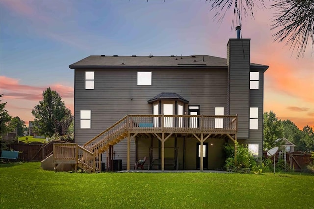 4249 Caveat Ct, Fairburn, GA 30213 - back of house at dusk with a deck, a chimney, and stairs