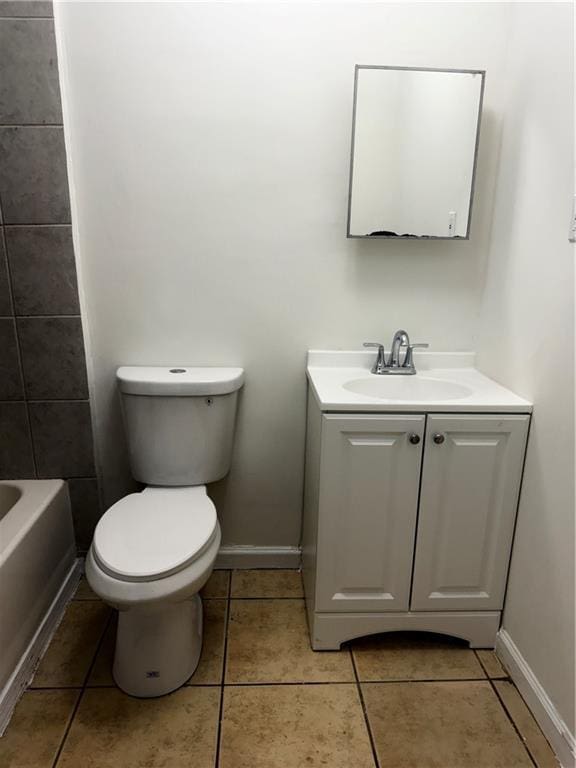 210 Ormond St SW, Atlanta, GA 30315 - bathroom featuring vanity, toilet, tile patterned floors, and baseboards