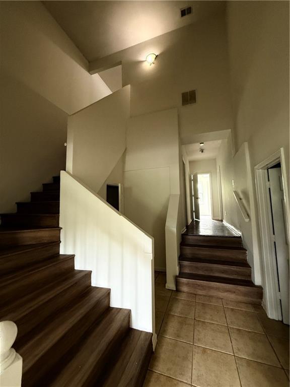 210 Ormond St SW, Atlanta, GA 30315 - stairway featuring a towering ceiling and tile patterned flooring