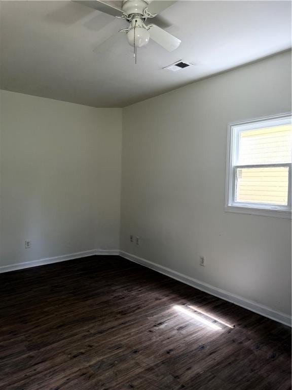 210 Ormond St SW, Atlanta, GA 30315 - spare room featuring dark wood-style floors, baseboards, and a ceiling fan