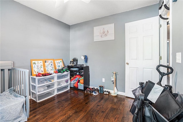 bedroom featuring wood finished floors, baseboards, and ceiling fan