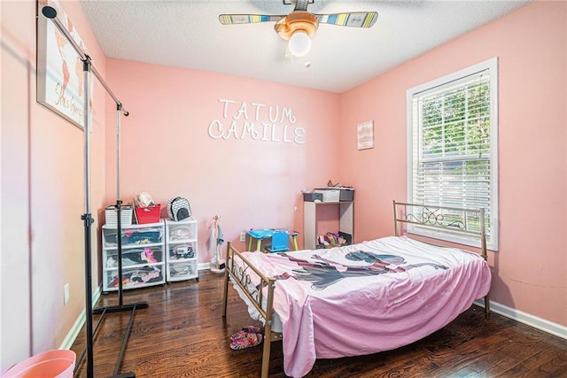 bedroom featuring wood finished floors, baseboards, and a ceiling fan