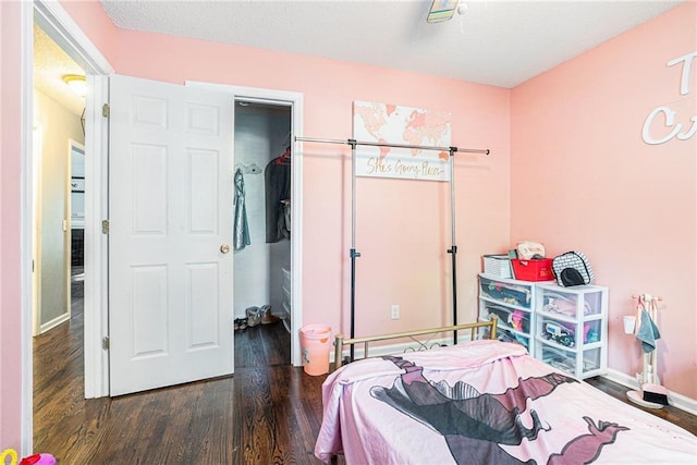 bedroom with wood finished floors and baseboards