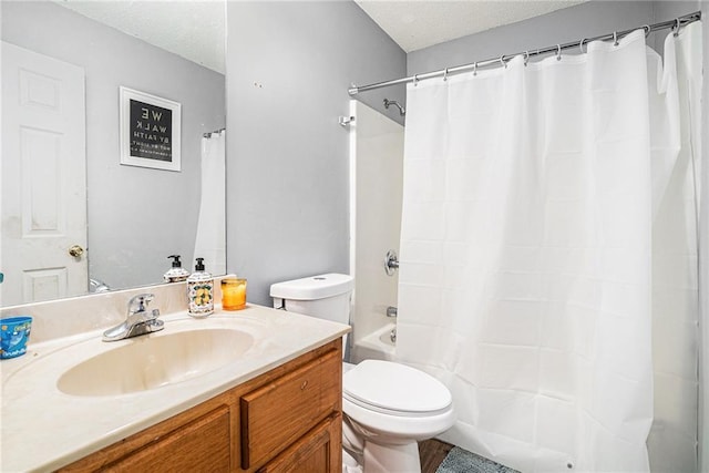 full bath with a textured ceiling, toilet, vanity, and shower / bath combo