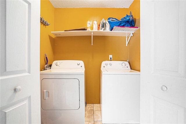 washroom featuring independent washer and dryer and light tile patterned floors