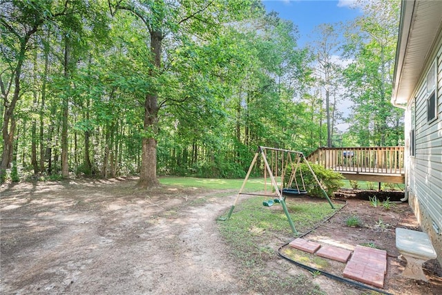 view of yard with a playground and a deck