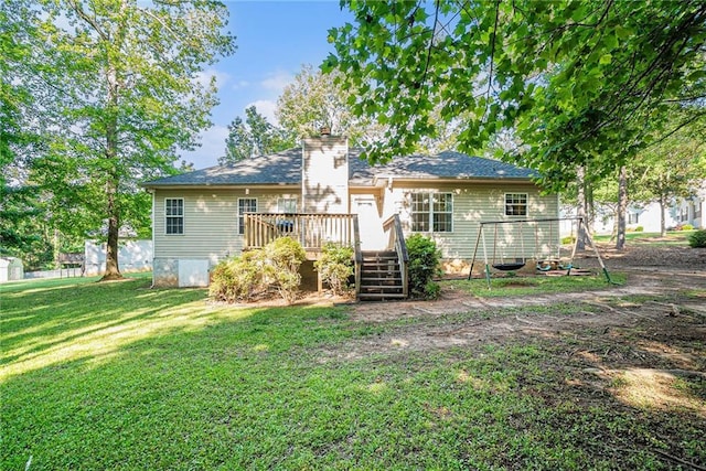 back of house with a lawn, a wooden deck, and a chimney