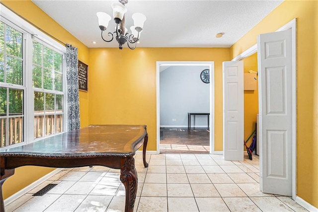 dining room featuring a chandelier, baseboards, and light tile patterned floors