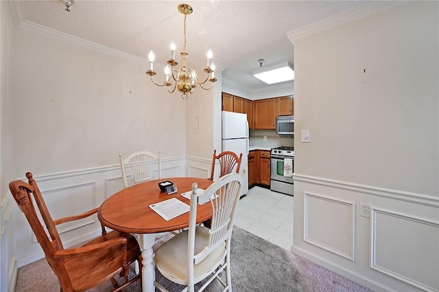 1800 Clairmont Lk Unit 326, Decatur, GA 30033 - dining area featuring a wainscoted wall, a textured ceiling, an inviting chandelier, and ornamental molding