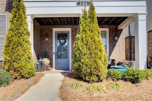 doorway to property with brick siding