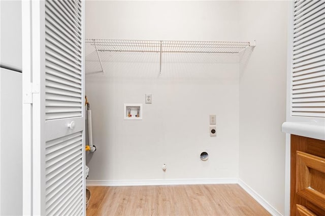 laundry area featuring laundry area, light wood finished floors, gas dryer hookup, hookup for an electric dryer, and washer hookup