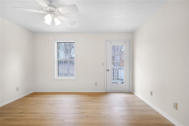 spare room with ceiling fan, baseboards, and light wood-style floors