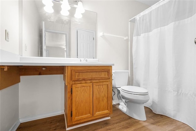 bathroom featuring vanity, curtained shower, wood finished floors, and toilet