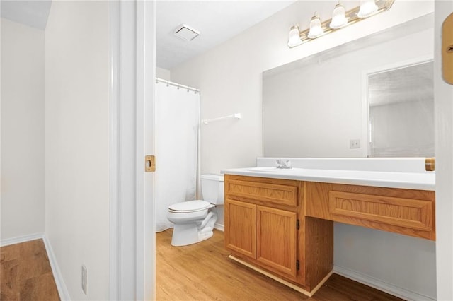 full bath featuring curtained shower, visible vents, toilet, vanity, and wood finished floors