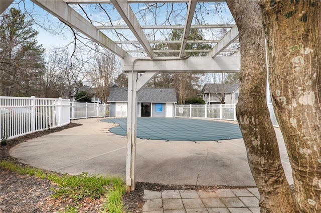 view of pool featuring a fenced in pool, an outbuilding, fence, a patio area, and a pergola