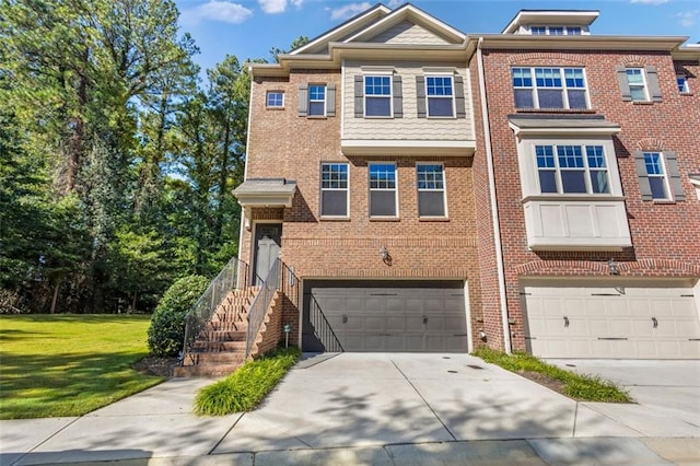 view of property with a garage and a front lawn