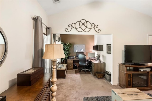 office space featuring light carpet and vaulted ceiling