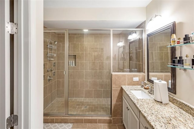 bathroom featuring tile patterned floors, vanity, and walk in shower